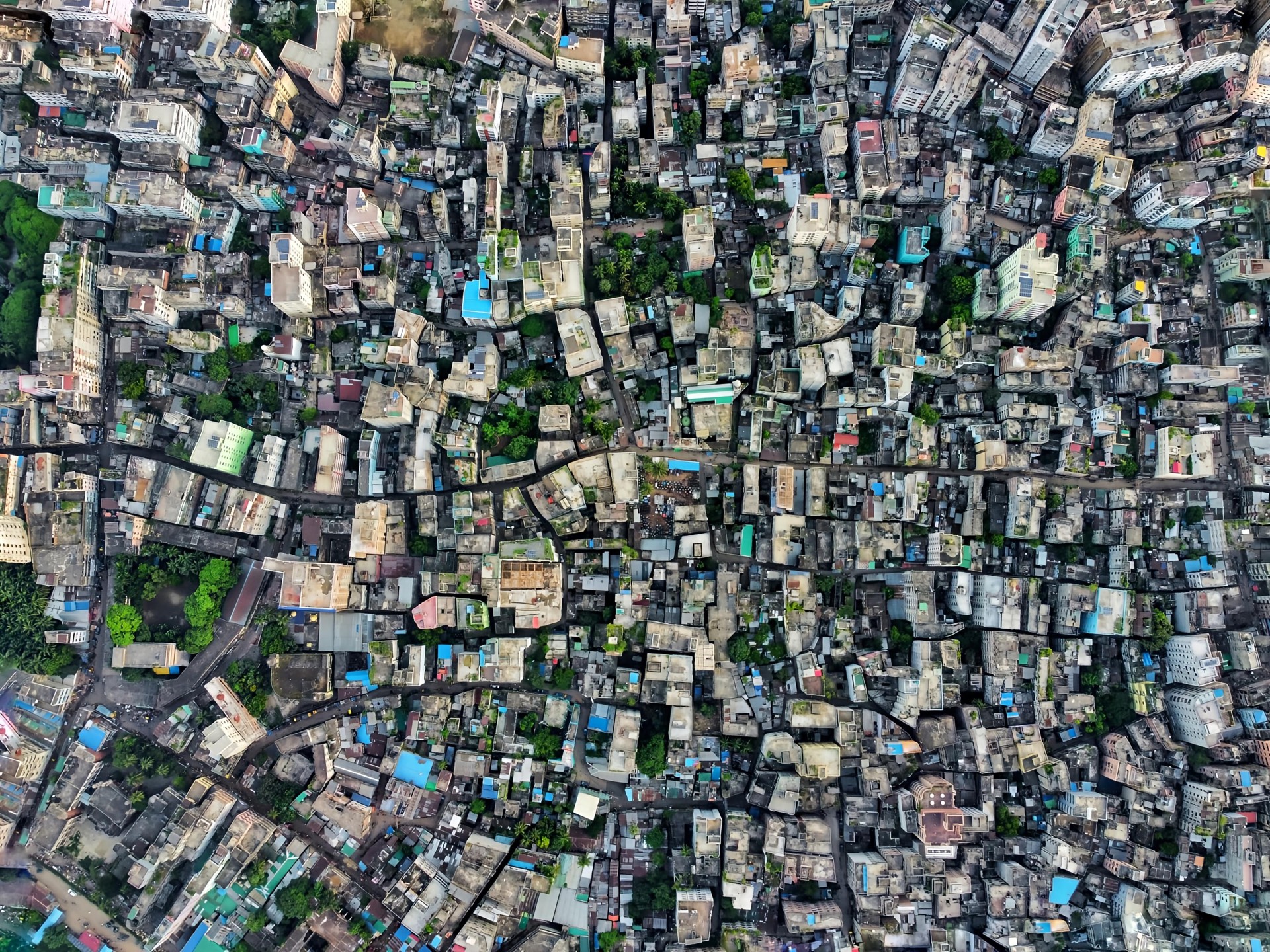 A vivid overhead map of a dense megacity - the kind of living world visitors explore on a Cartian exhibit screen